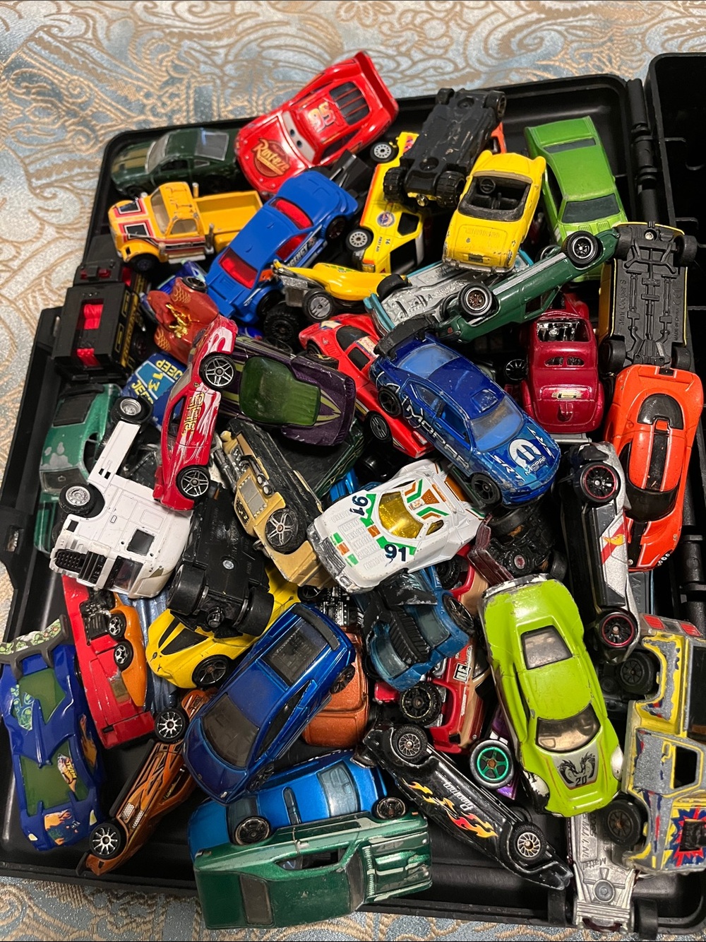 61 Hotwheels and other misc cars and trucks with case included As is